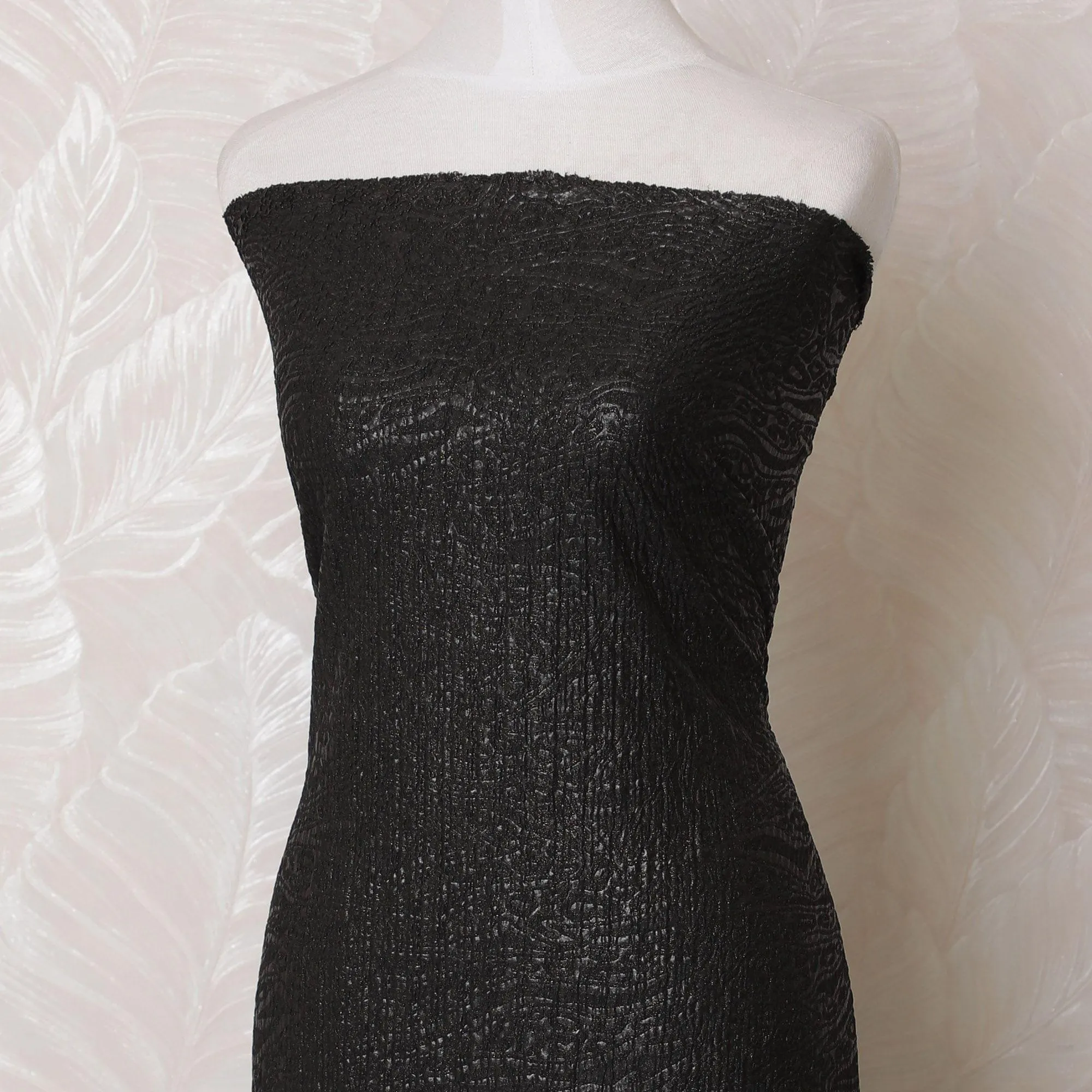 Black synthetic stretchable brocade fabric with same gold metallic shine in self design-D15983